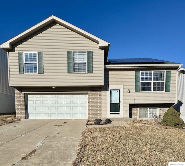 view of front of house with solar panels and a garage