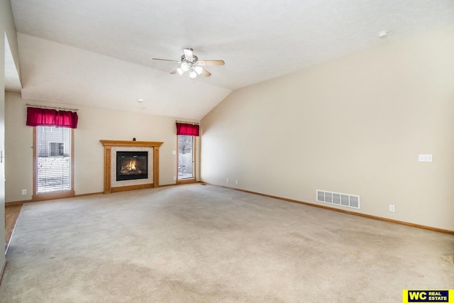 unfurnished living room featuring carpet flooring, ceiling fan, and vaulted ceiling