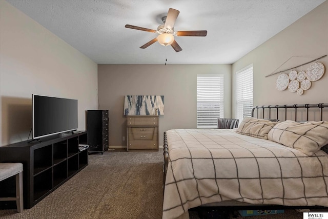 carpeted bedroom with ceiling fan and a textured ceiling