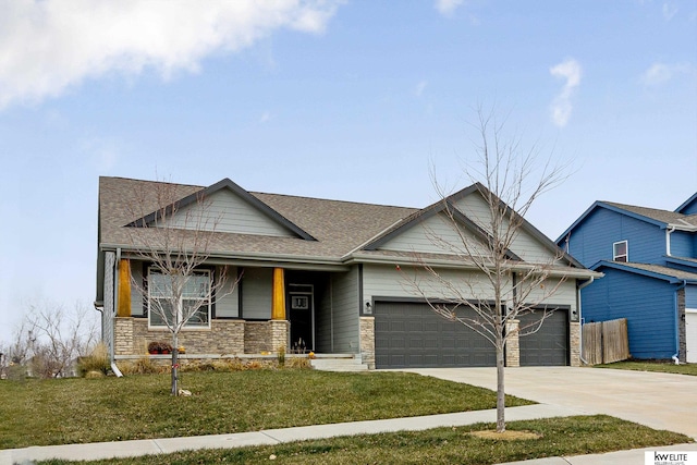 view of front of property featuring a garage and a front lawn