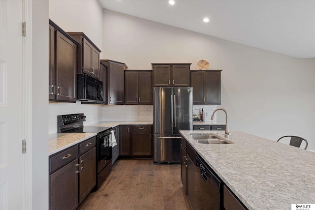 kitchen with black appliances, dark hardwood / wood-style flooring, sink, and tasteful backsplash