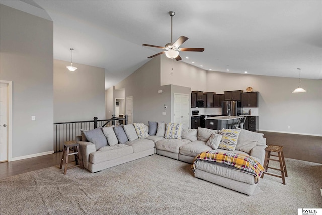 living room with ceiling fan and high vaulted ceiling