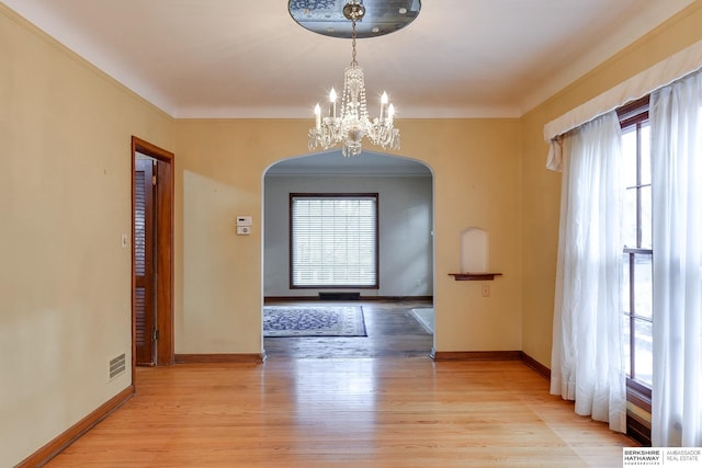 entryway featuring an inviting chandelier and light hardwood / wood-style flooring