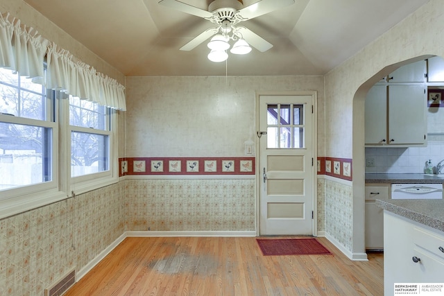 kitchen featuring ceiling fan, light hardwood / wood-style floors, and dishwasher