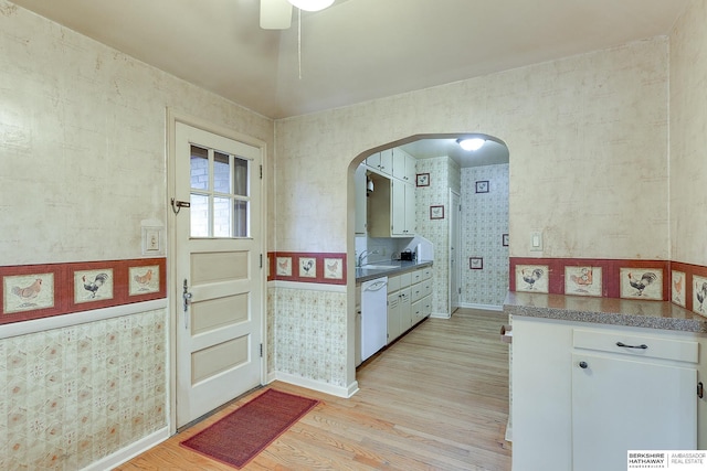 kitchen with dishwasher, white cabinets, light hardwood / wood-style floors, and sink