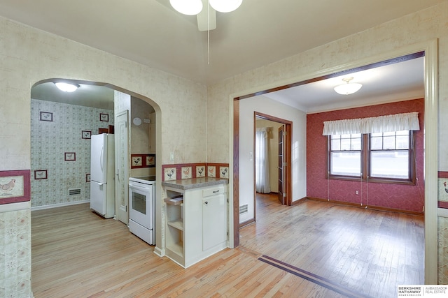 kitchen with ceiling fan, white cabinets, white appliances, and light wood-type flooring