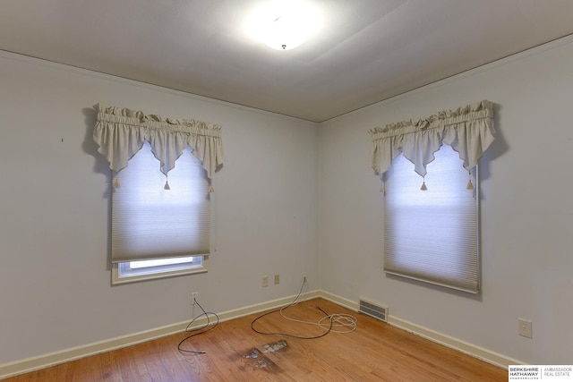 empty room with hardwood / wood-style floors