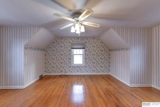 bonus room featuring light wood-type flooring, vaulted ceiling, and ceiling fan