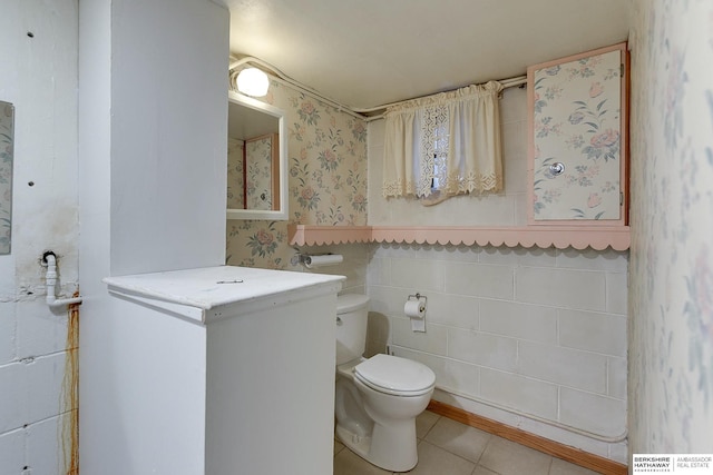 bathroom featuring tile patterned flooring and toilet