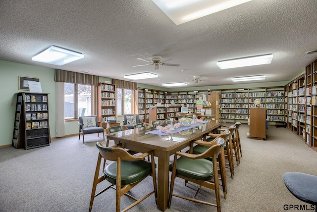 carpeted dining space with a textured ceiling