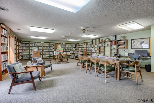 interior space with light carpet and a textured ceiling