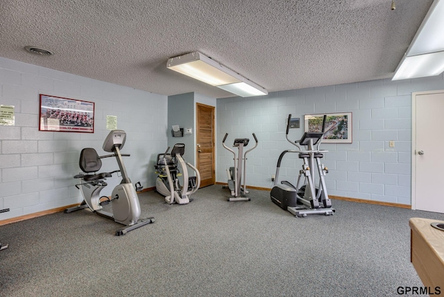 exercise area featuring a textured ceiling