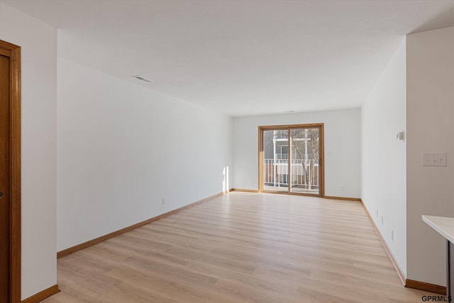 spare room featuring light hardwood / wood-style floors