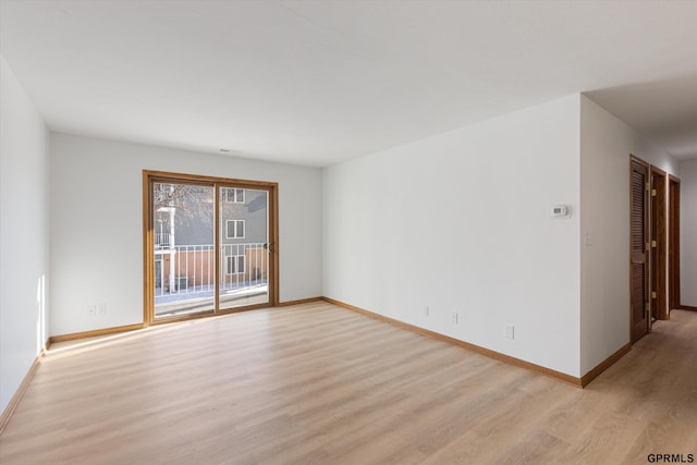 spare room featuring light hardwood / wood-style floors