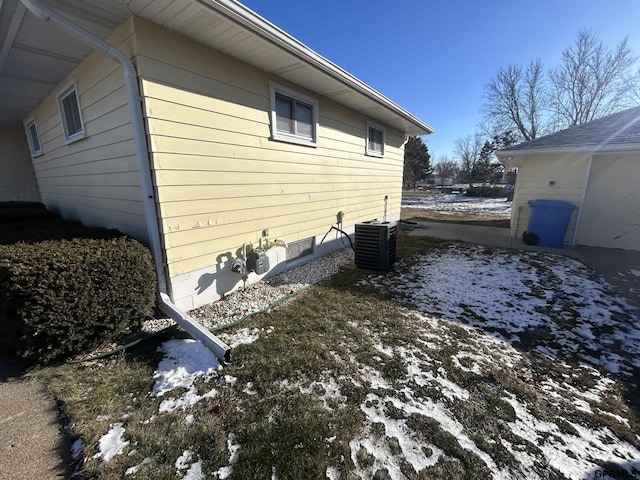 snow covered property featuring cooling unit