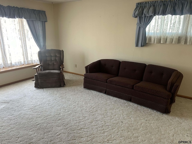 living room with a healthy amount of sunlight and light colored carpet