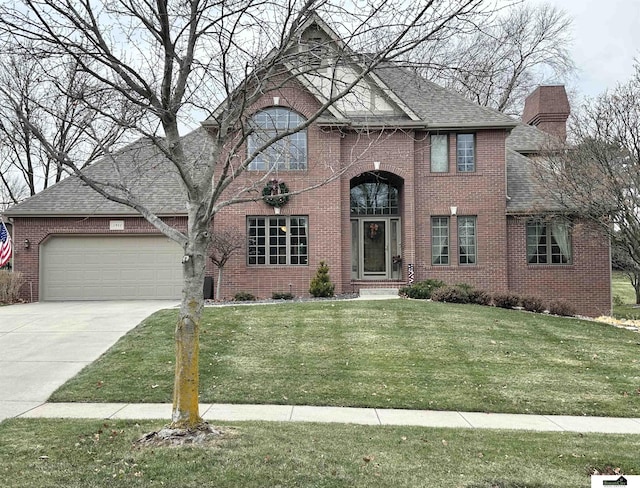 view of front of property with a garage and a front yard