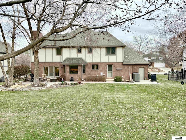 rear view of property with a lawn, a patio area, and central AC