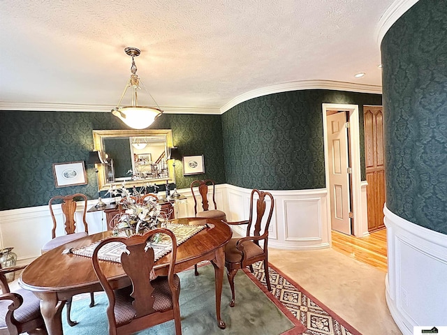 dining area featuring a textured ceiling and crown molding