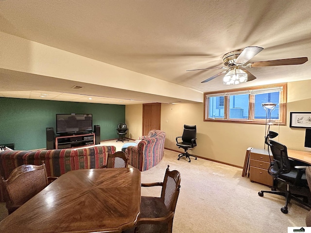 dining area featuring light carpet and ceiling fan