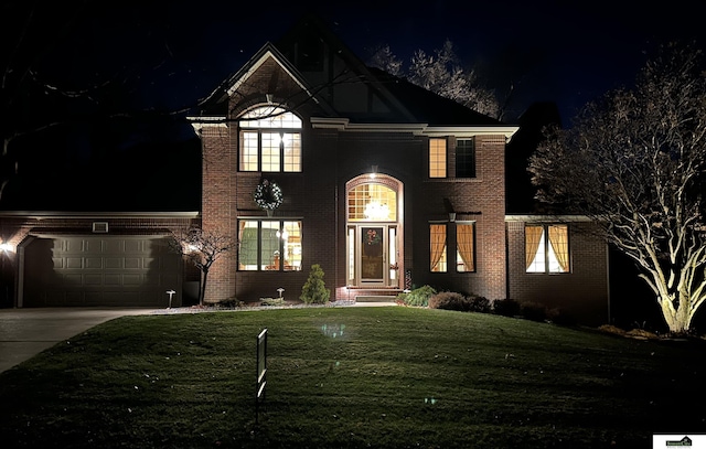 view of property featuring a lawn and a garage