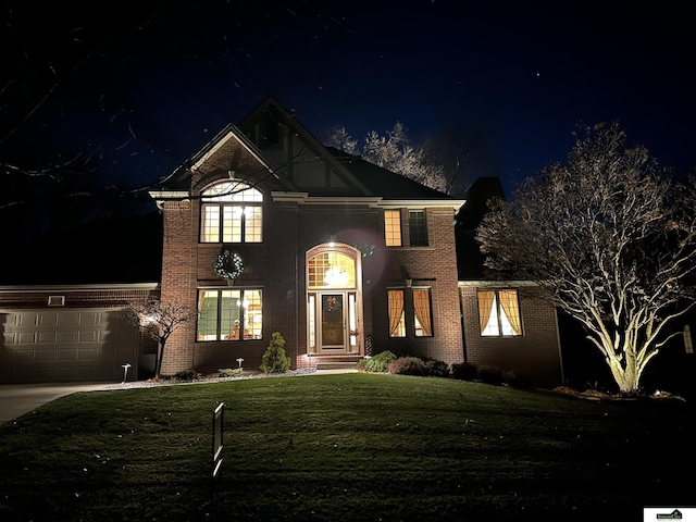 view of front property with a yard and a garage