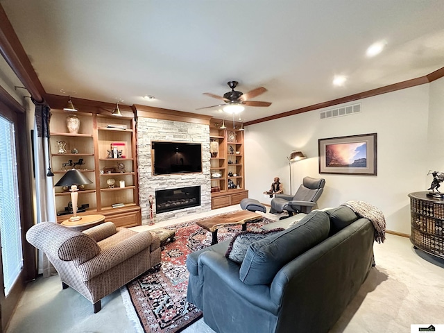 living room featuring a stone fireplace, crown molding, ceiling fan, built in features, and light colored carpet