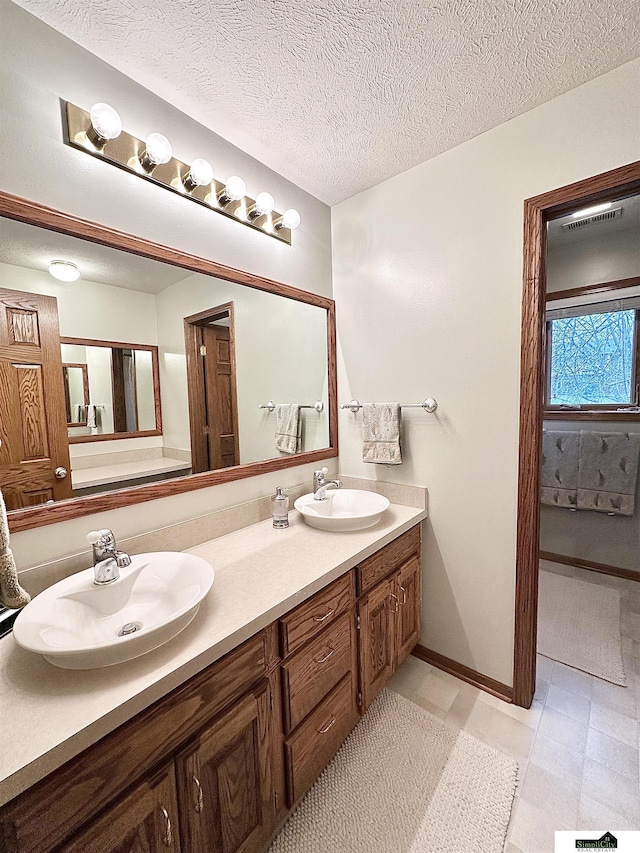 bathroom featuring vanity and a textured ceiling