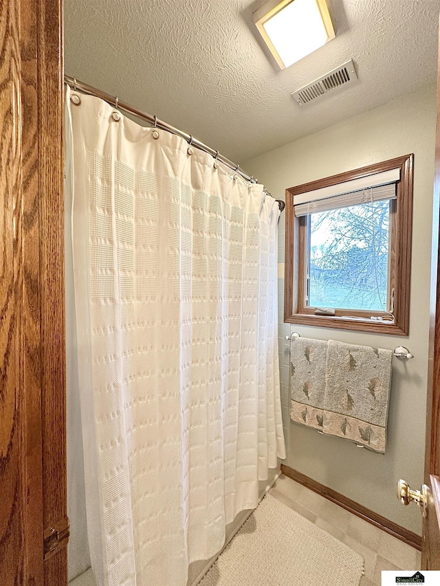 bathroom with a textured ceiling