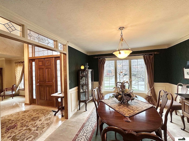 dining room with ornamental molding and a textured ceiling