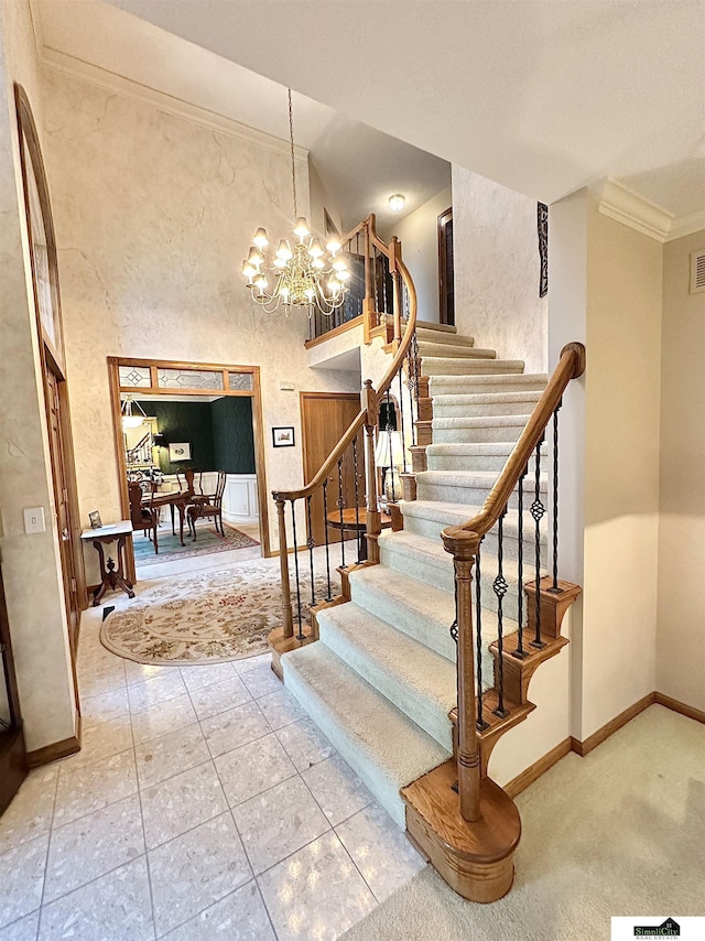 stairway with tile patterned flooring, a notable chandelier, and crown molding