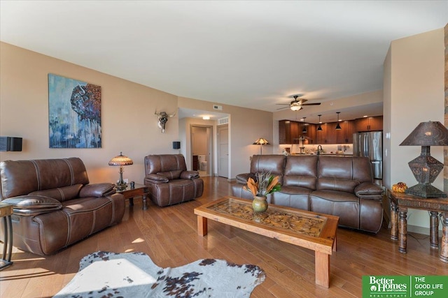 living room with ceiling fan and light hardwood / wood-style floors