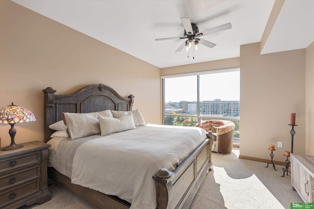 bedroom with ceiling fan and light carpet