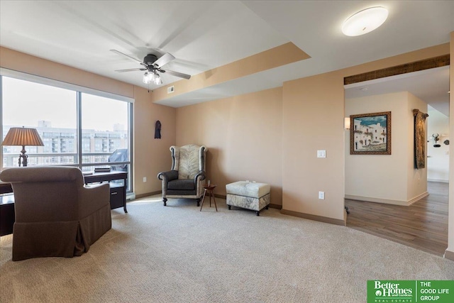 sitting room with carpet flooring and ceiling fan