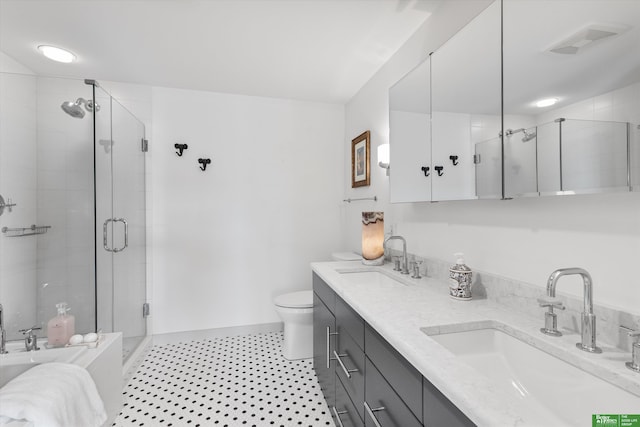 bathroom featuring a shower with door, vanity, and toilet