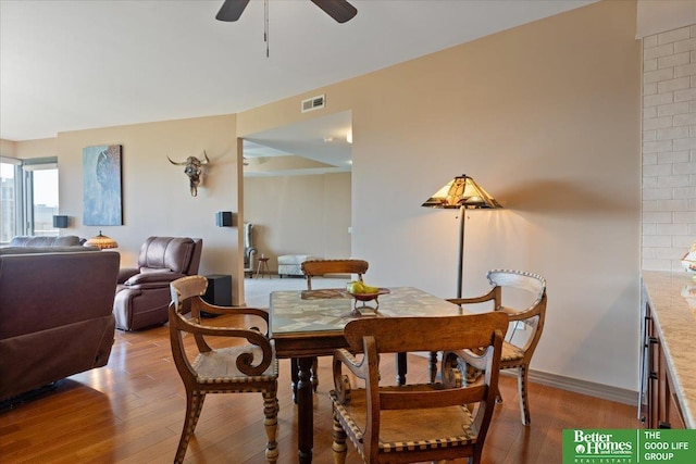 dining space featuring ceiling fan and light wood-type flooring