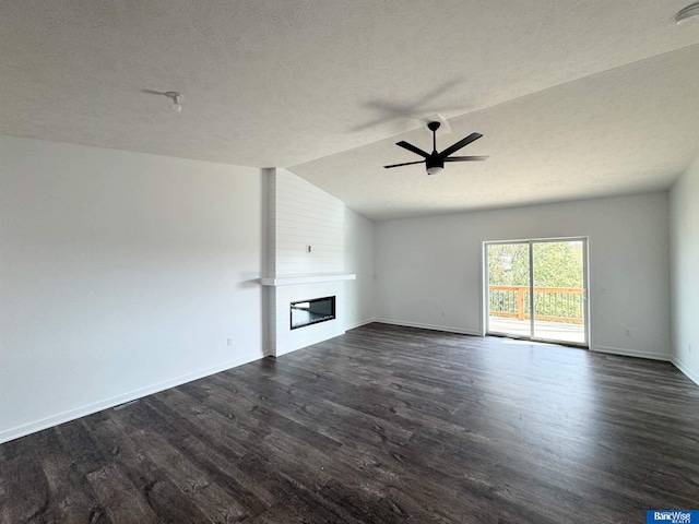 unfurnished living room with dark hardwood / wood-style flooring, ceiling fan, a fireplace, and lofted ceiling