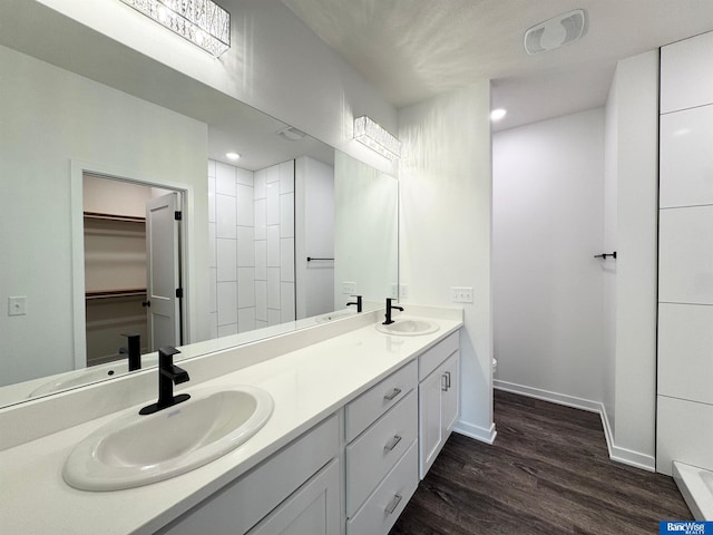 bathroom with toilet, vanity, and hardwood / wood-style flooring