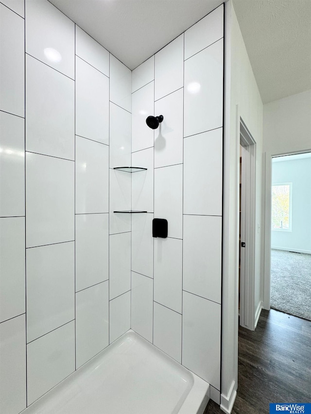 bathroom featuring hardwood / wood-style flooring and walk in shower