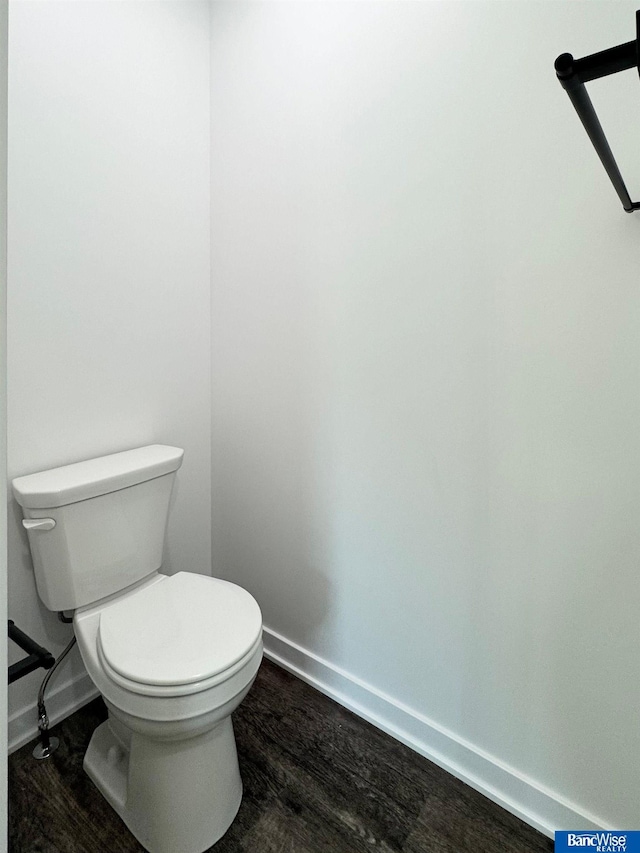 bathroom with hardwood / wood-style floors and toilet