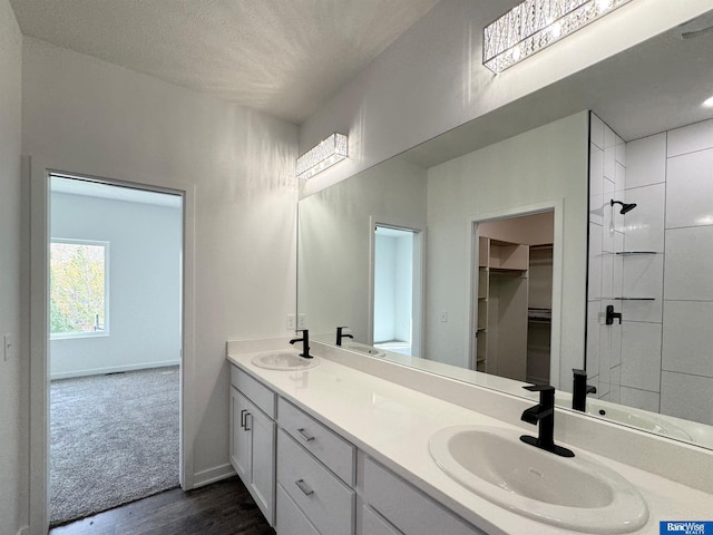 bathroom with hardwood / wood-style floors, vanity, a textured ceiling, and toilet