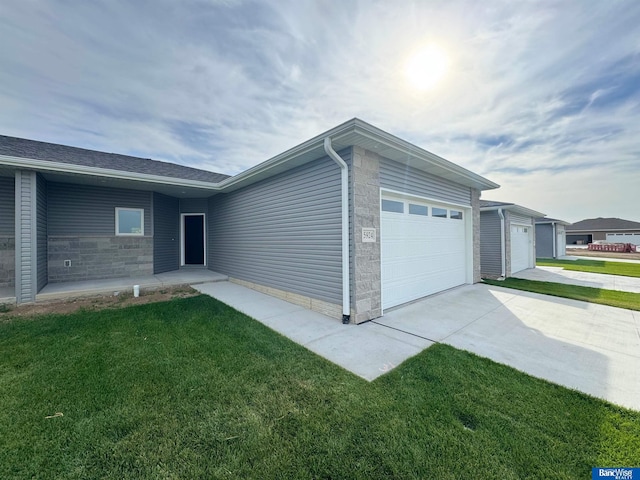 view of property exterior with a garage and a lawn