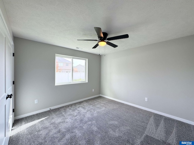 carpeted empty room featuring ceiling fan and a textured ceiling