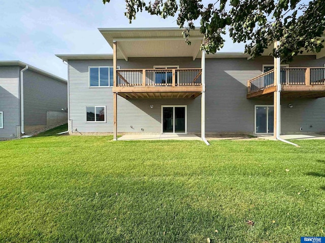 rear view of house with a patio and a lawn