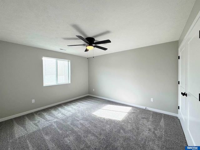 empty room with a textured ceiling, carpet floors, and ceiling fan