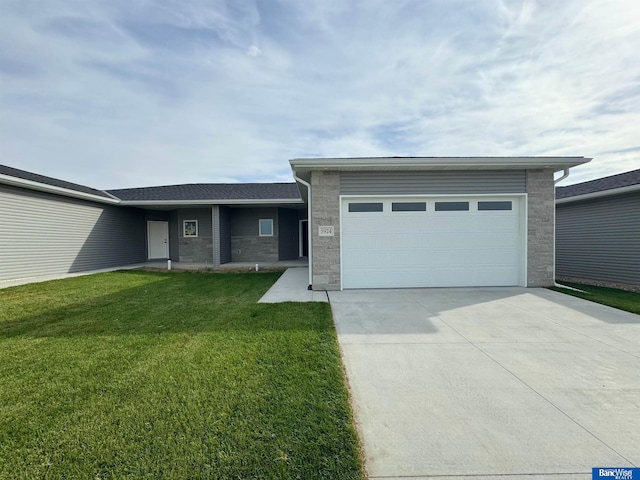 view of front of property with a garage and a front yard