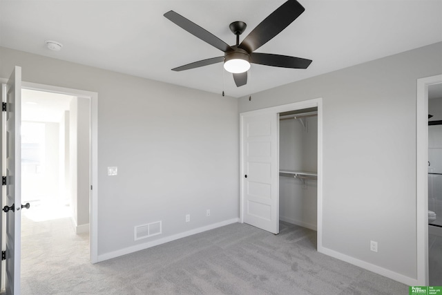 unfurnished bedroom featuring ceiling fan, light colored carpet, and a closet