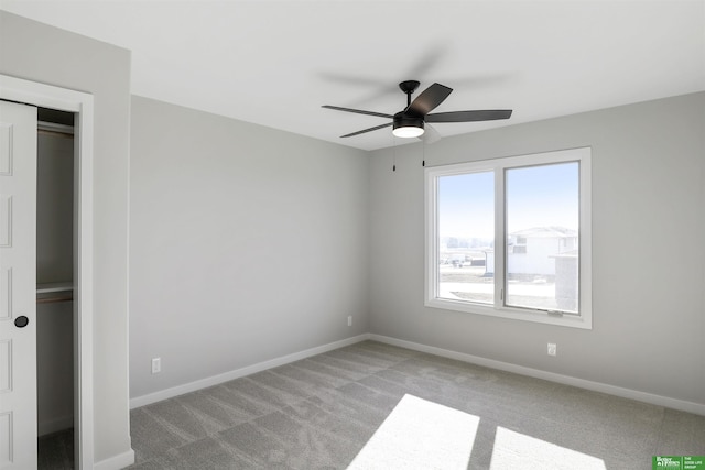 unfurnished bedroom with ceiling fan, a closet, and light colored carpet