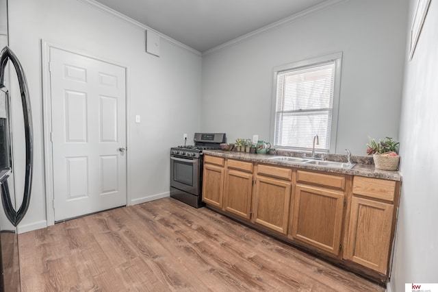 kitchen with black gas range, sink, light hardwood / wood-style flooring, crown molding, and refrigerator