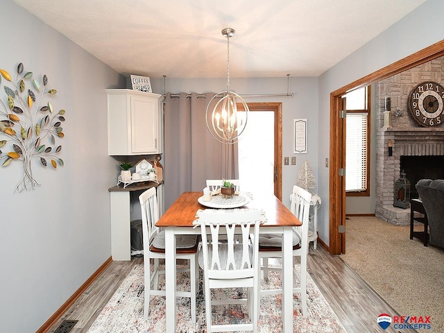 dining room with light hardwood / wood-style flooring and a chandelier